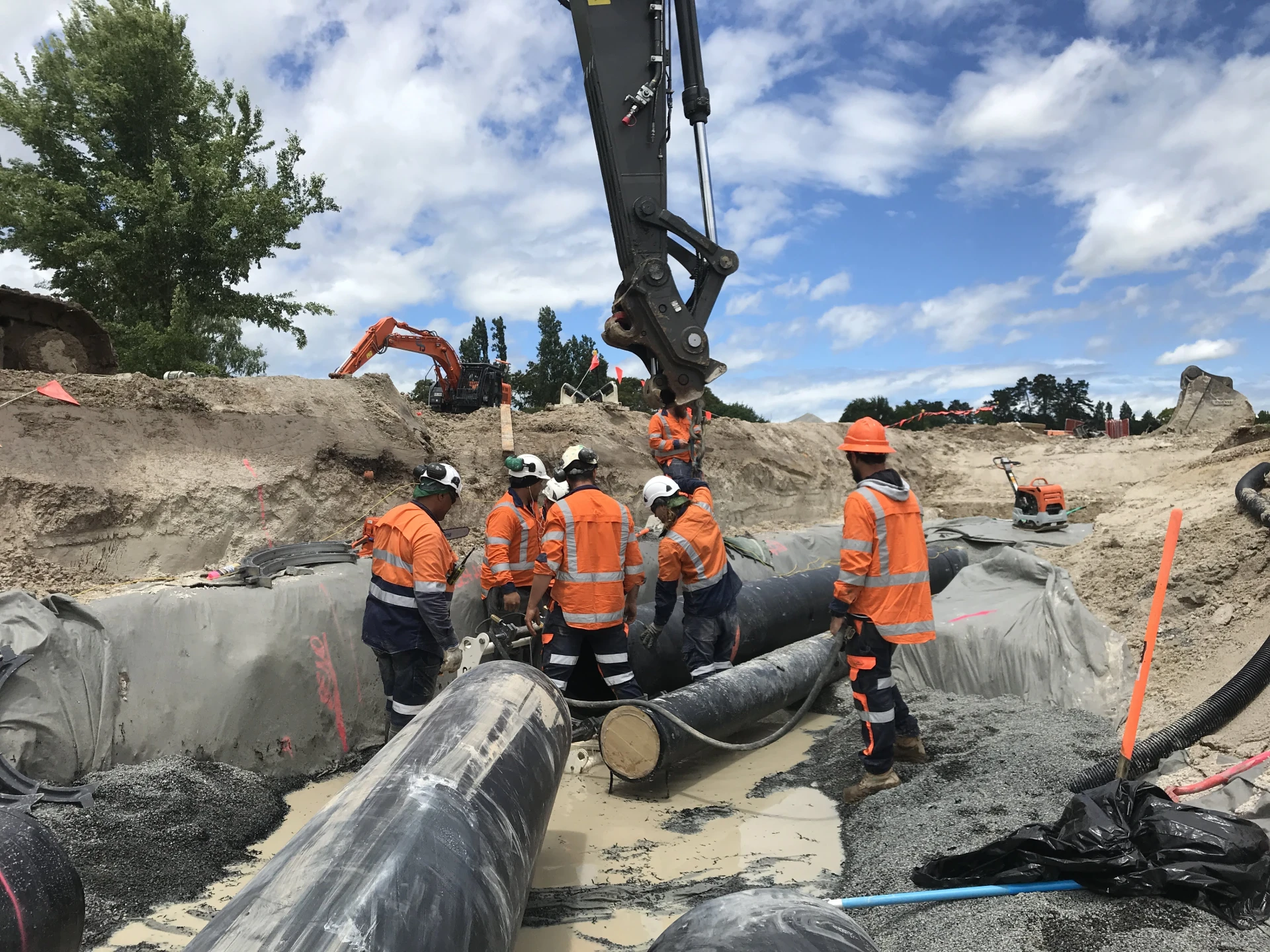Staff working on pipe Image 1